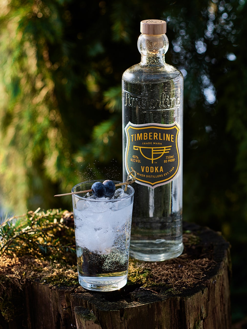 Timberline Vodka bottle and cocktail on stump